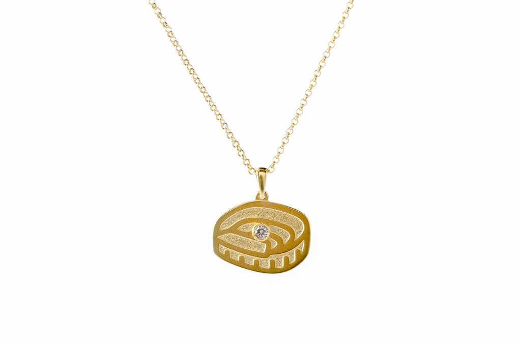 Colgante del FC Barcelona acabado en oro de 18K, con un diamante del césped del Spotify Camp Nou engastado en su centro sobre un fondo blanco.